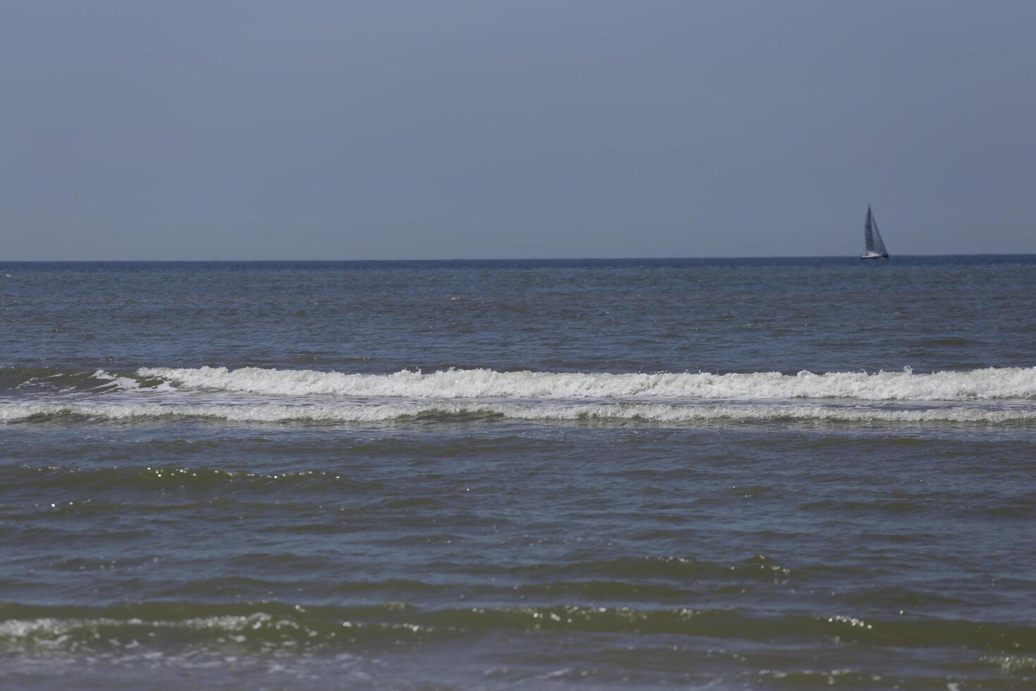 sailboat on the north sea, seen from the shore photo