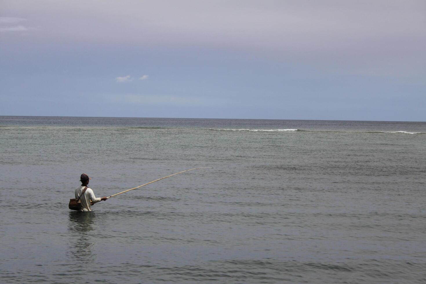 fisherman in the sea photo