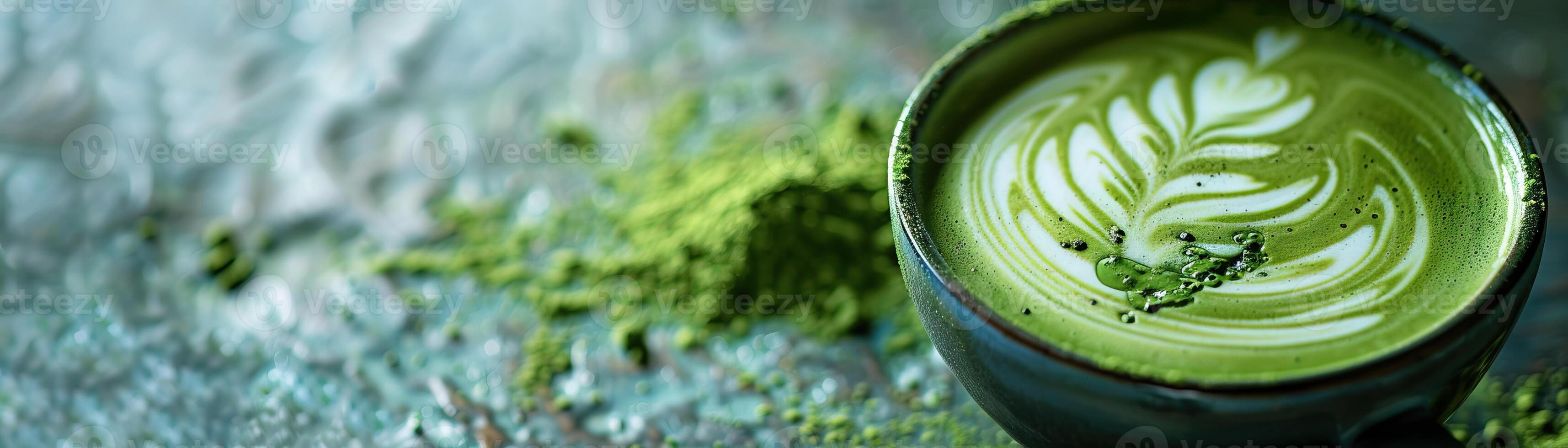 Matcha green tea latte with beautiful latte art on a blue stone table. photo