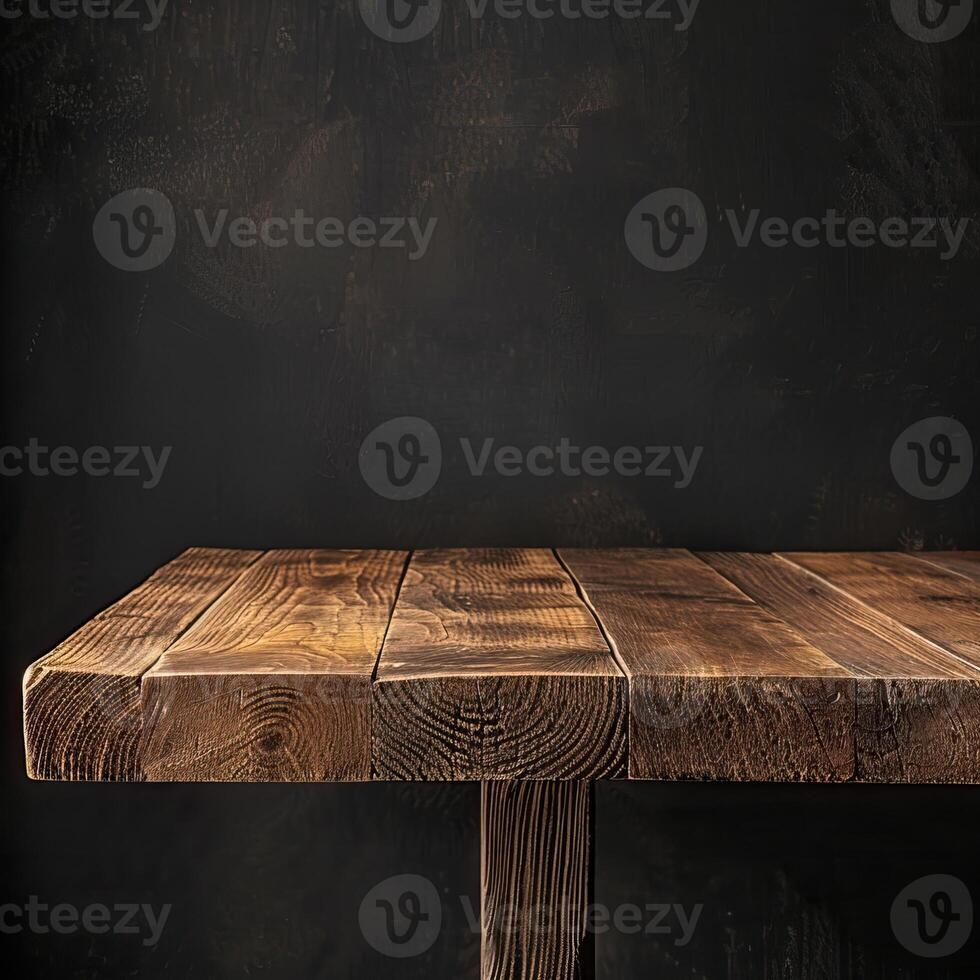Rustic wooden table against a dark background photo