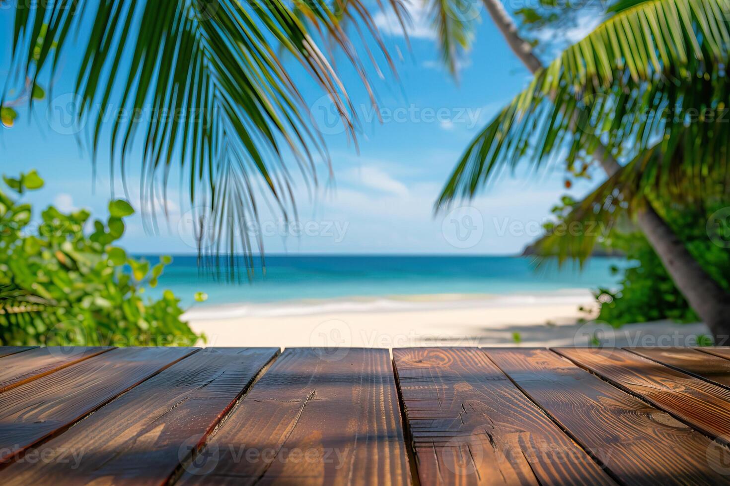 An empty wooden table with palm trees in the background photo