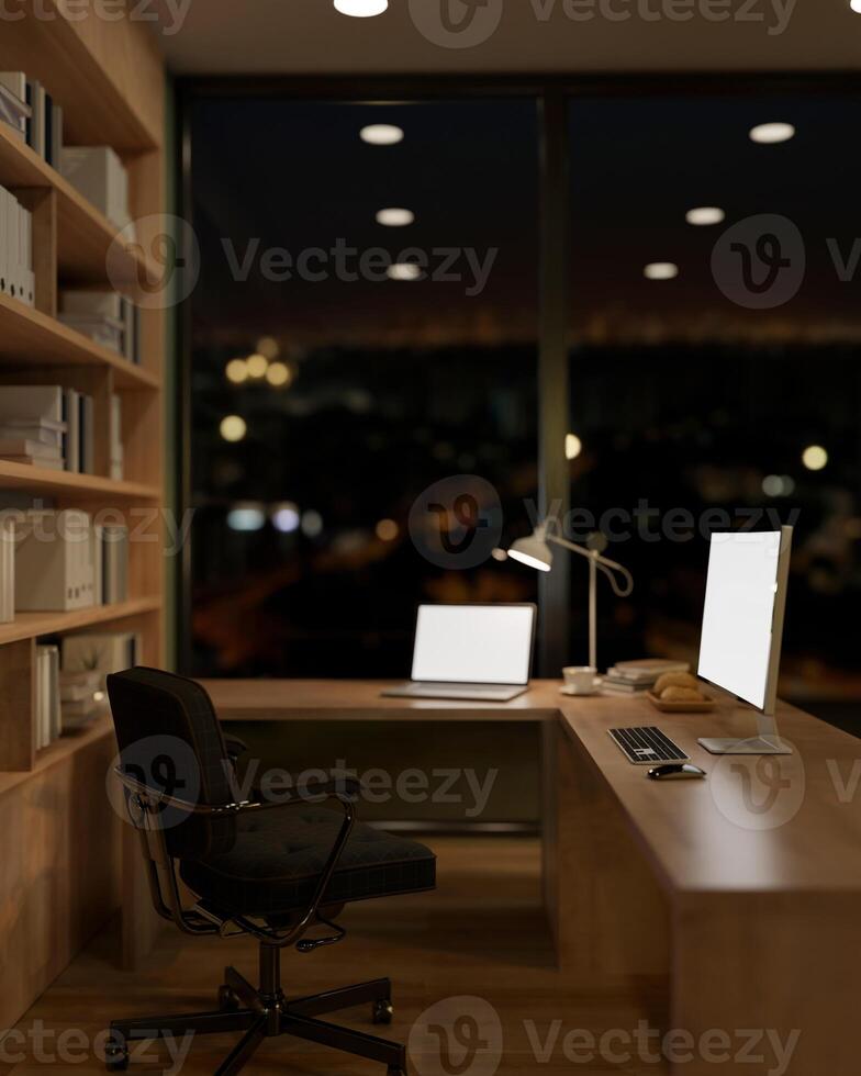 The interior design of a contemporary office at night features a laptop and a PC computer on a table photo