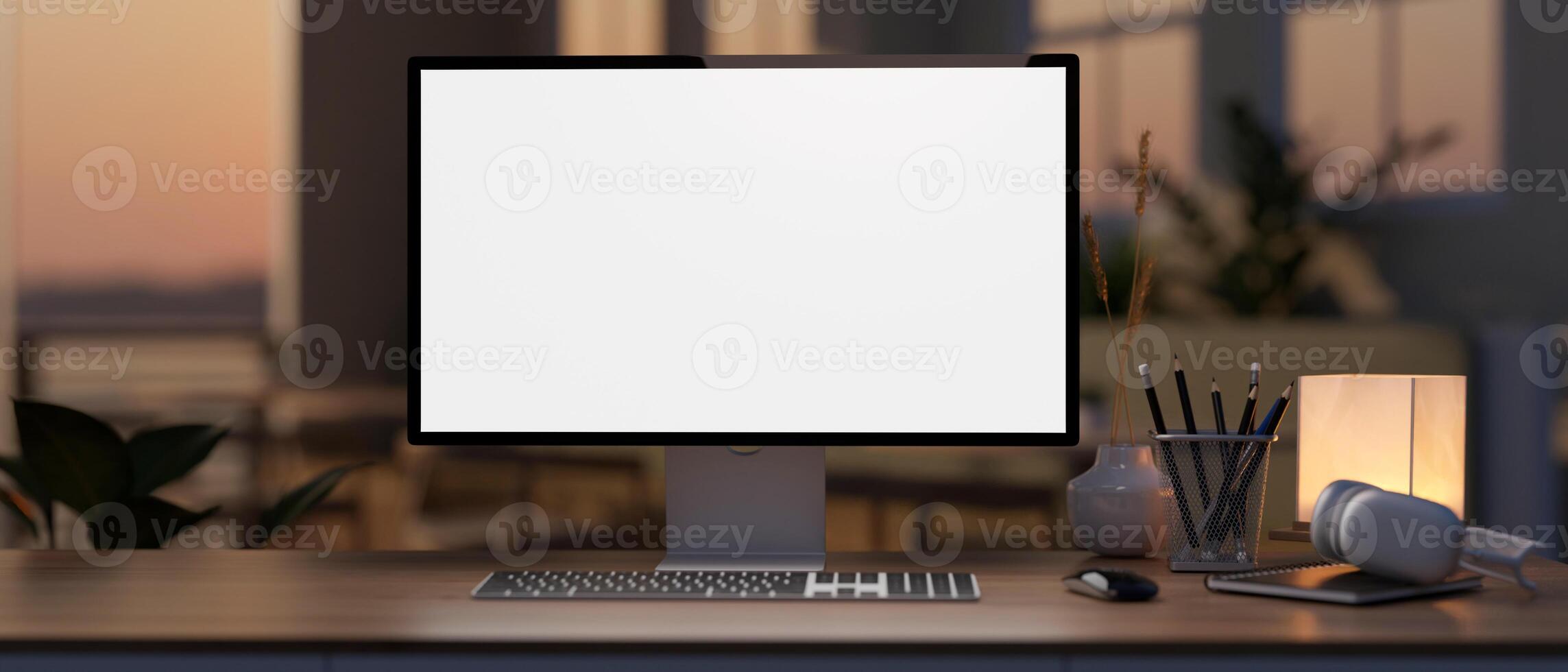 A white-screen computer mockup on a hardwood desk in a modern home office during sunset time. photo