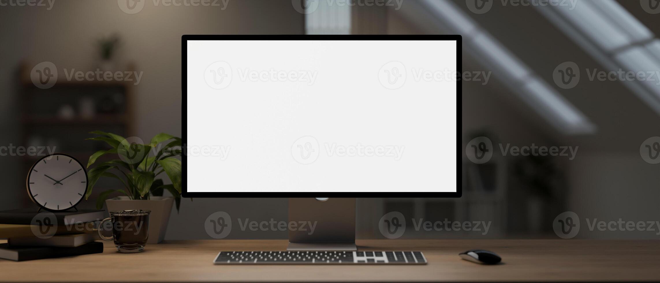 A computer desk with a computer mockup and accessories on a hardwood table in a room. photo