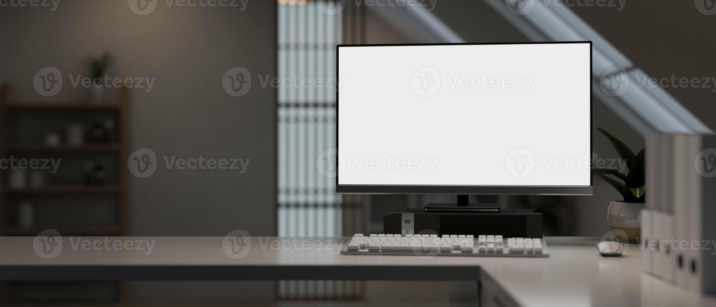 A modern office with a white-screen computer mockup and a keyboard on a table in a modern room. photo