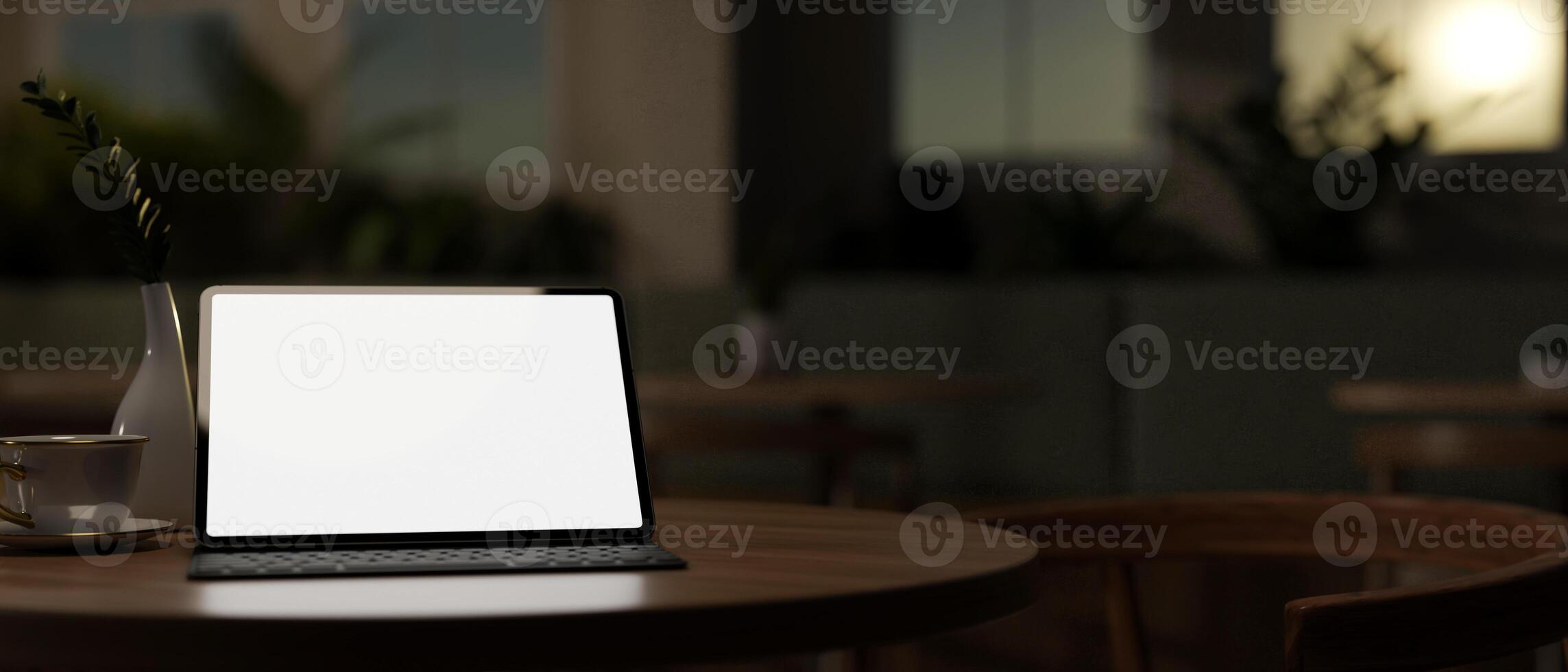 A close-up image of a digital tablet mockup on a wooden table in a dark room in the evening. photo