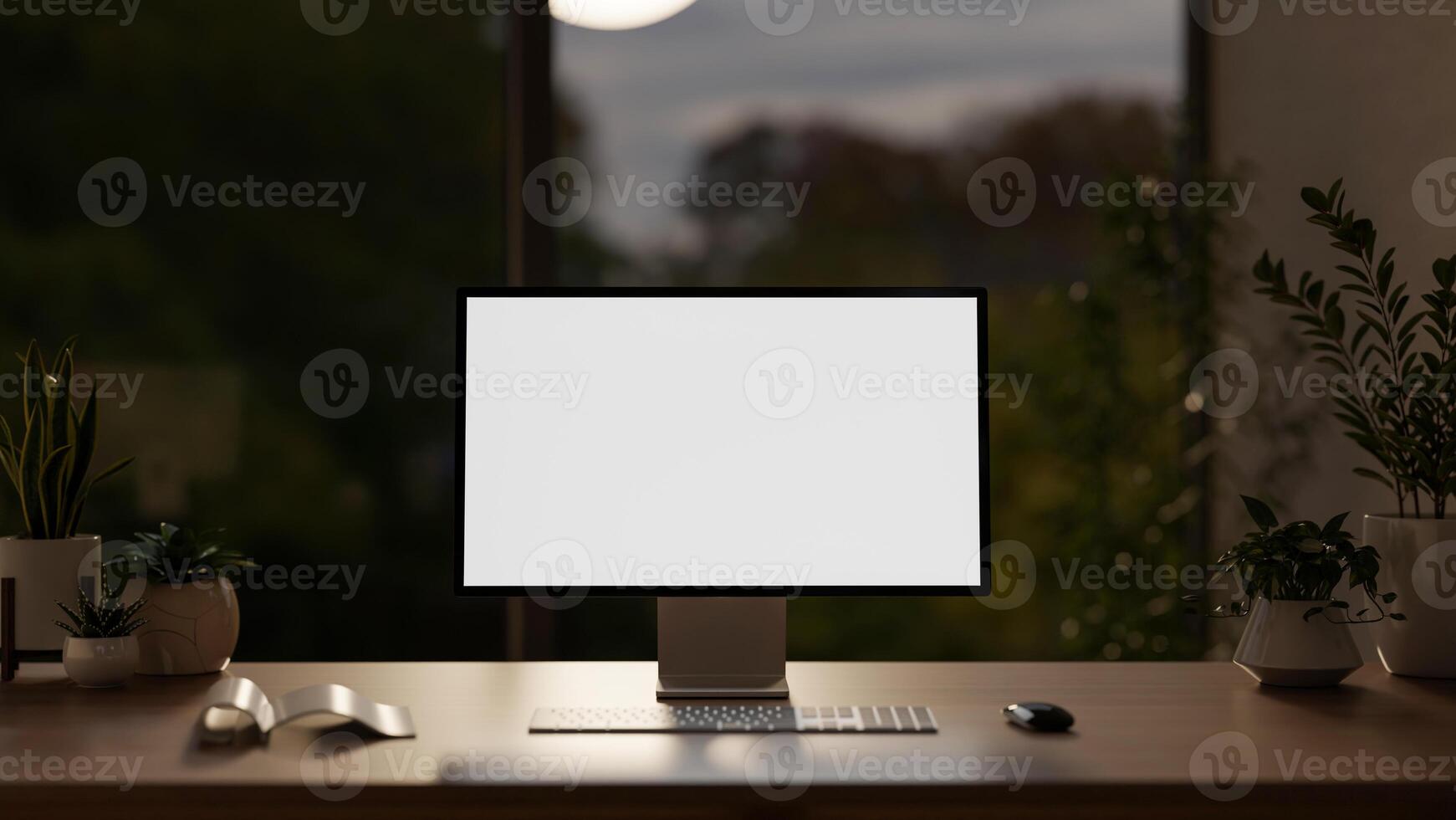 A modern dark office at night with a white-screen computer mockup and accessories on a wooden desk. photo