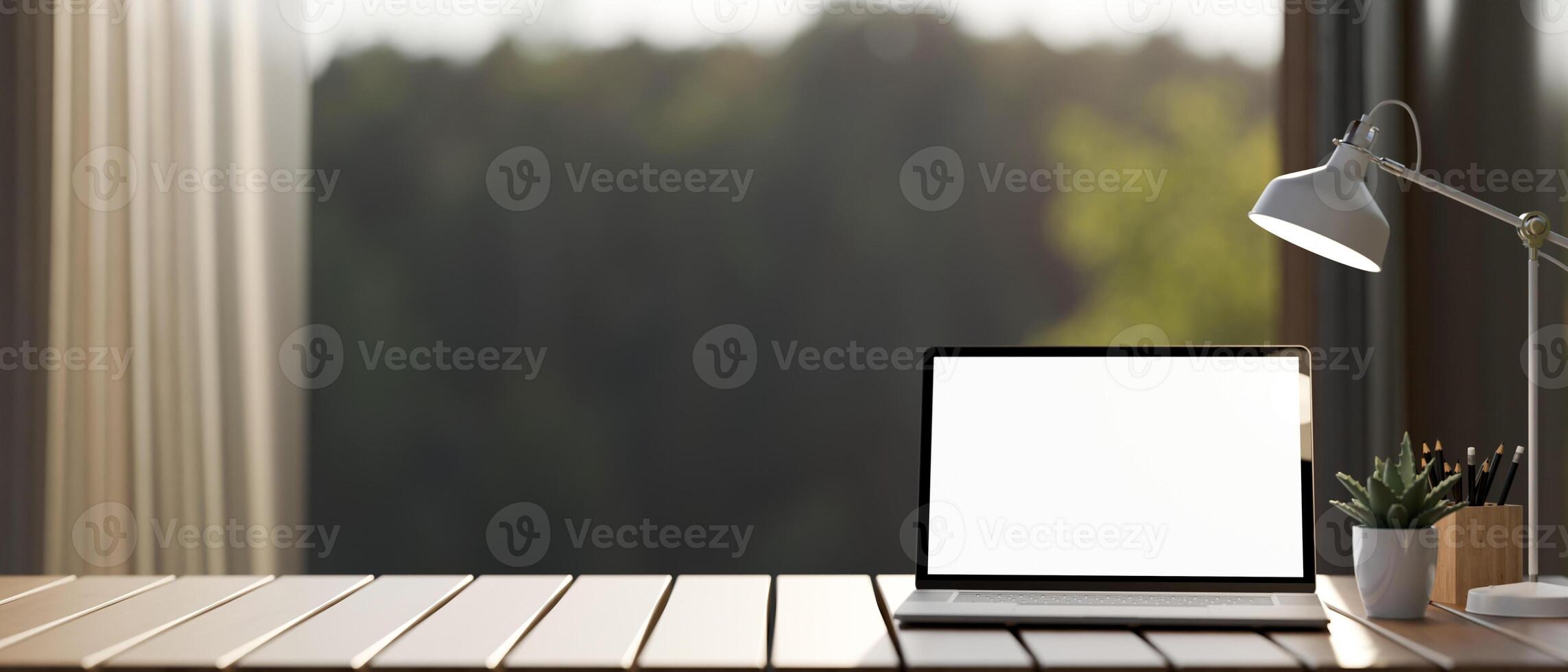 A laptop computer mockup and accessories on a wooden tabletop against the window with a nature view. photo