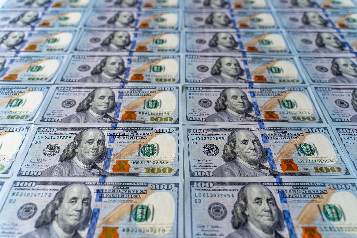 Profit from business with pile of American dollars. Focus on Frankiln. Man on hundred banknote photo