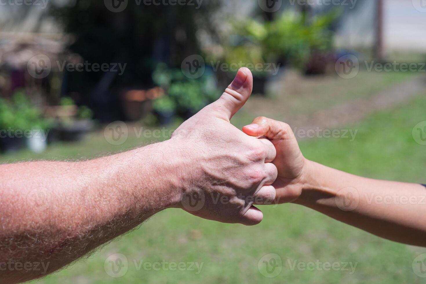 Close-up of two hands showing signals of success and good photo