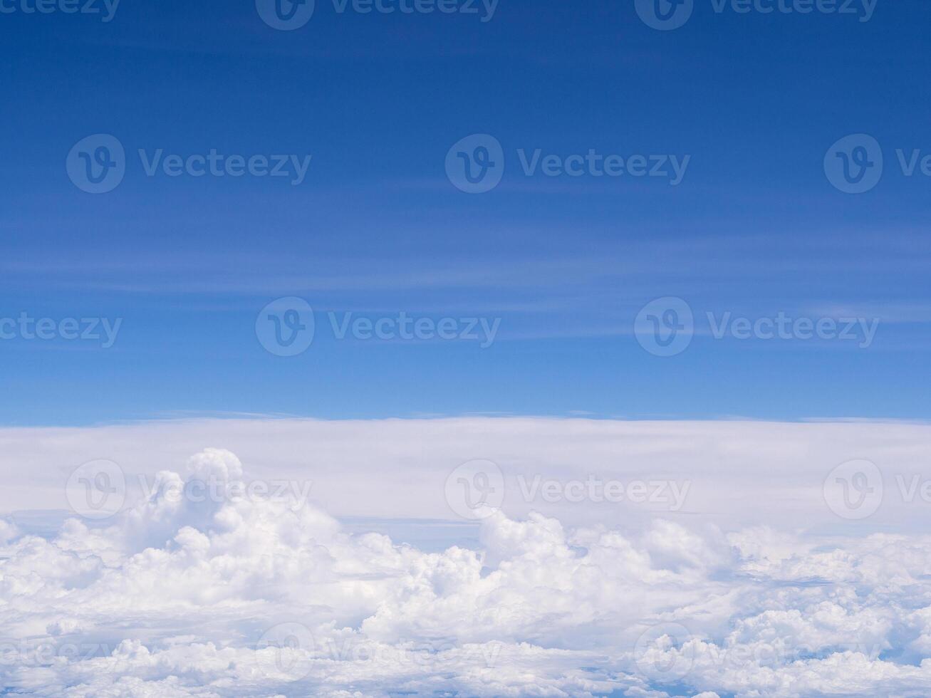 Aerial view of cloudscape seen through airplane window photo