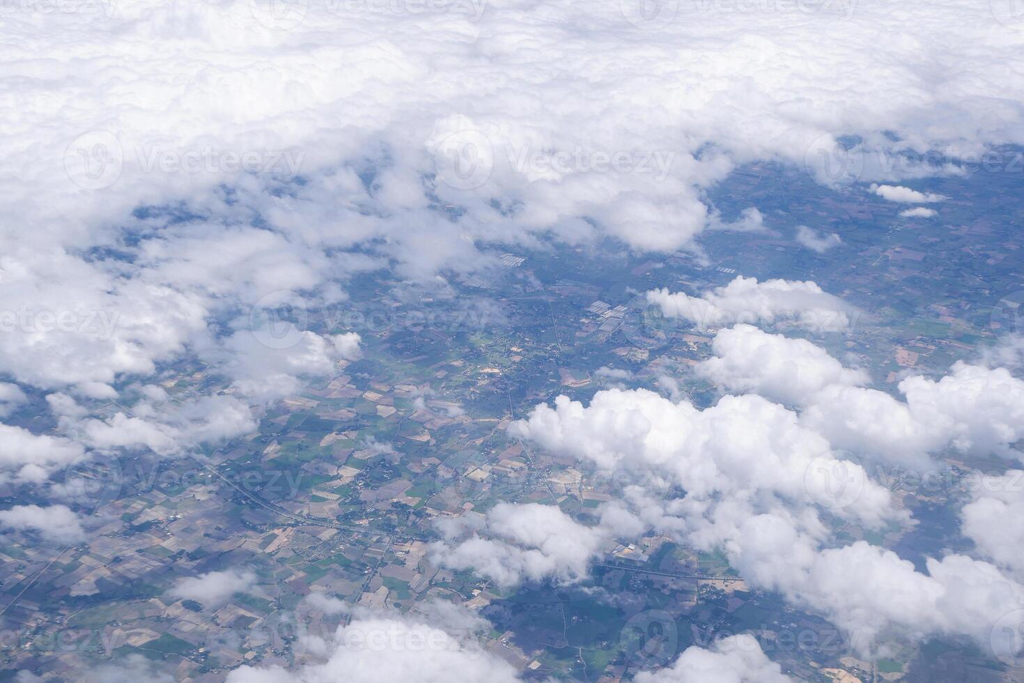 Aerial view of clouds and sky seen through the airplane window photo