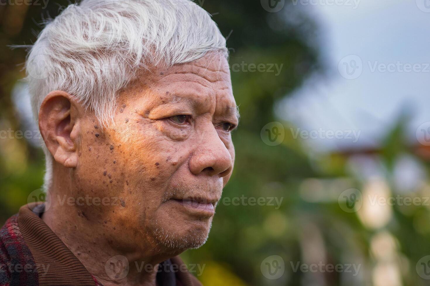 Close-up of face elderly man smiling. Space for text. Concept of aged people and healthcare photo