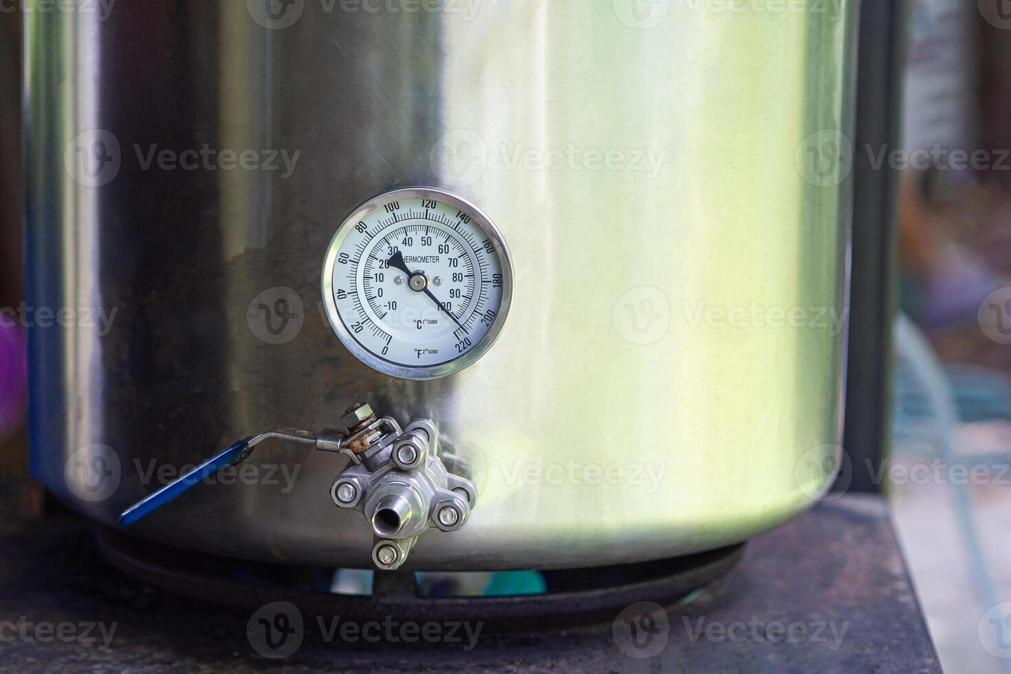 Close-up of alcohol thermometer on craft beer tank. Selective focus. Homebrewing process photo