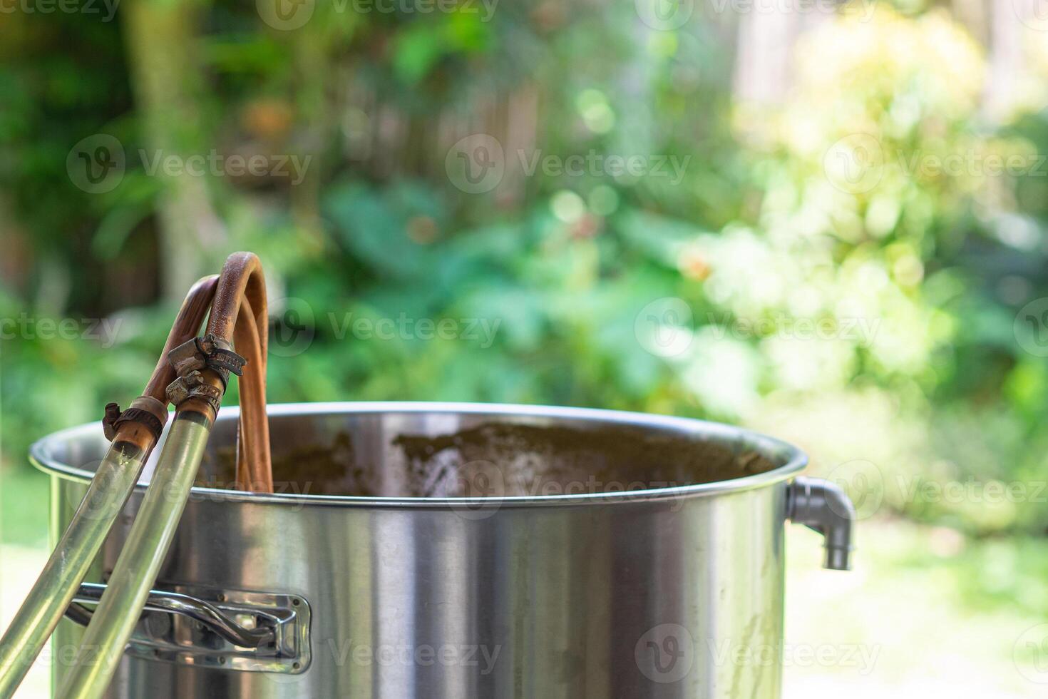 A copper immersion heat exchanger is used in the craft beer process. Selective focus. Homebrewing process photo