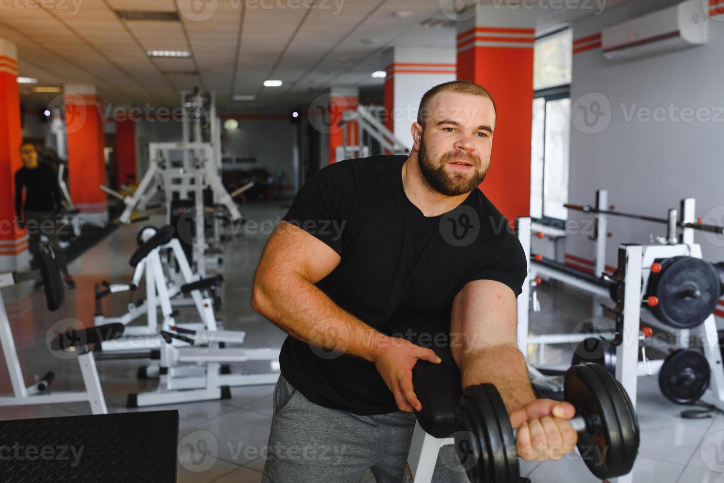 Young handsome man engaged in the gym photo