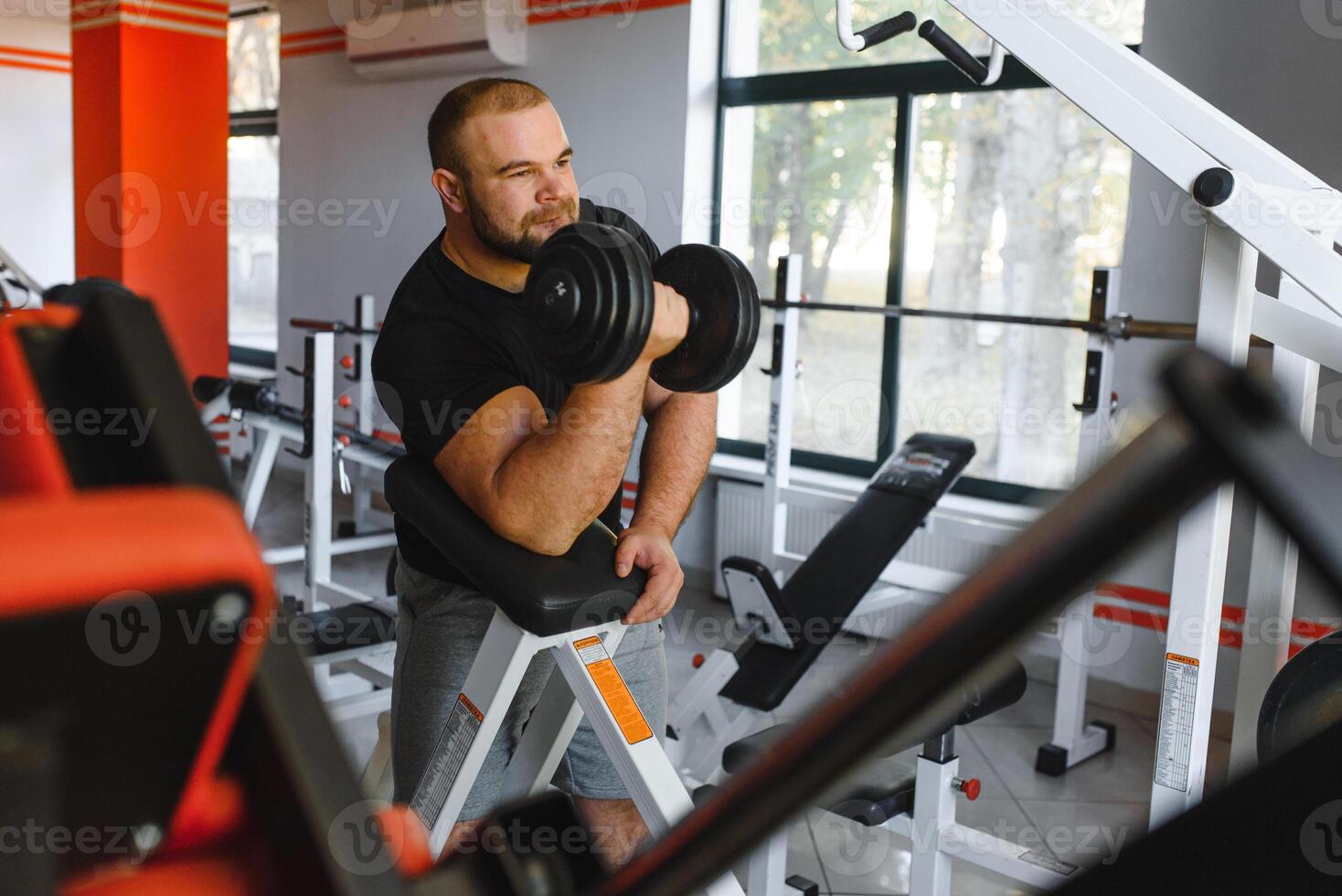 Young handsome man engaged in the gym photo