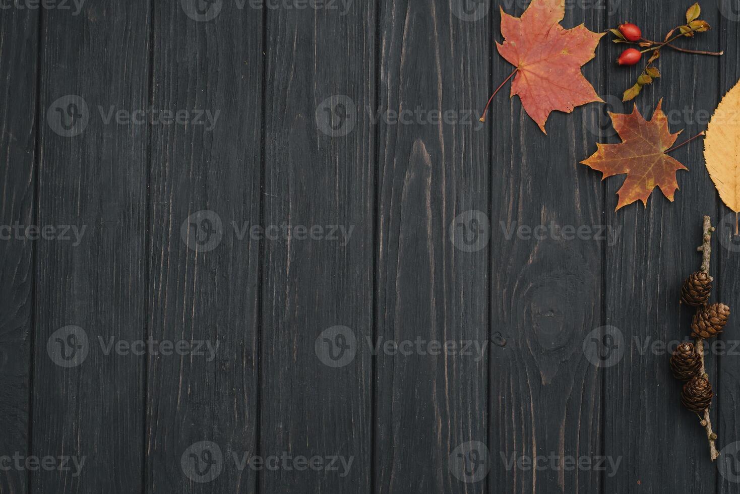 Background texture with old wooden table and yellow autumnal leaves. Autumn maple leaves on wooden background with copy space. Top view. photo