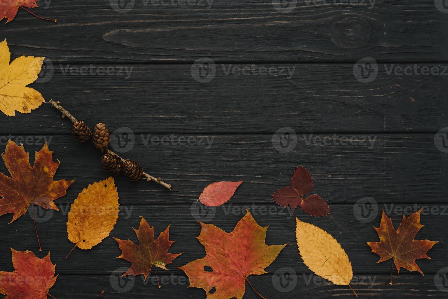 Background texture with old wooden table and yellow autumnal leaves. Autumn maple leaves on wooden background with copy space. Top view. photo