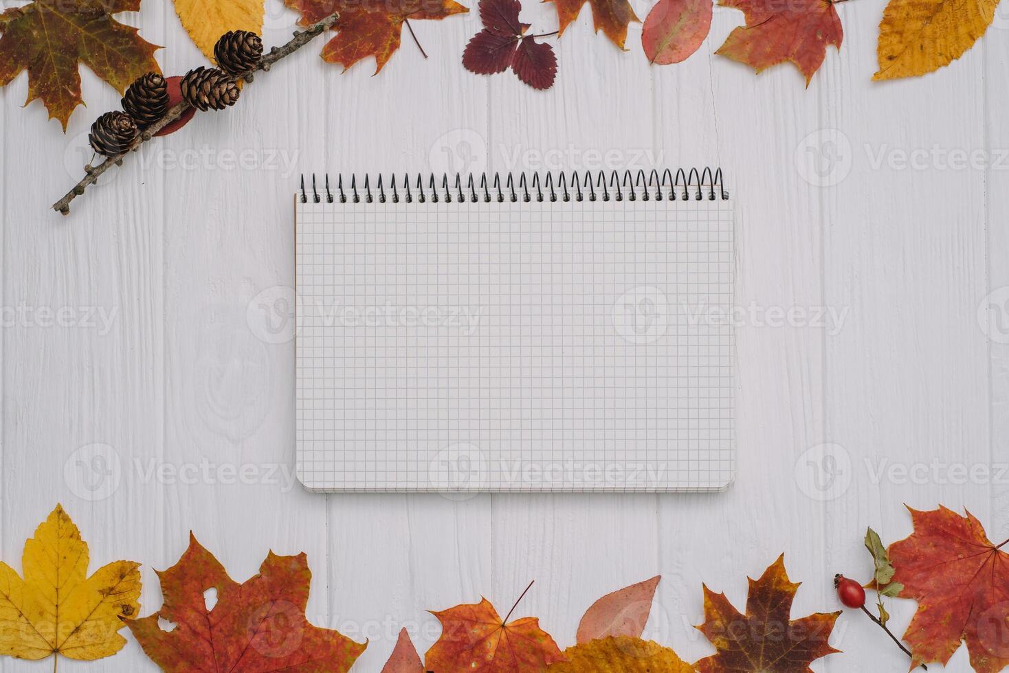 Background texture with old wooden table and yellow autumnal leaves. Autumn maple leaves on wooden background with copy space. Top view. photo