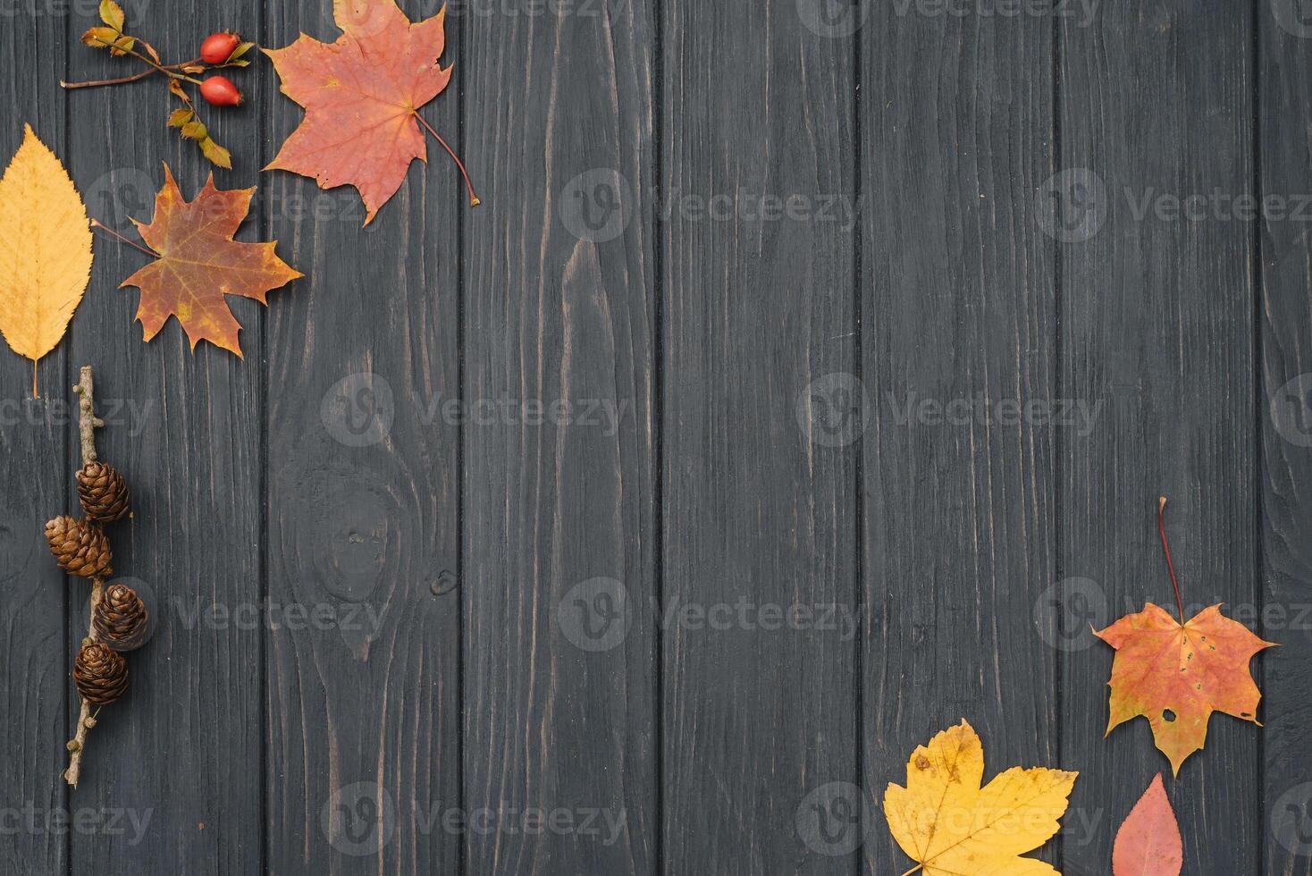 Background texture with old wooden table and yellow autumnal leaves. Autumn maple leaves on wooden background with copy space. Top view. photo