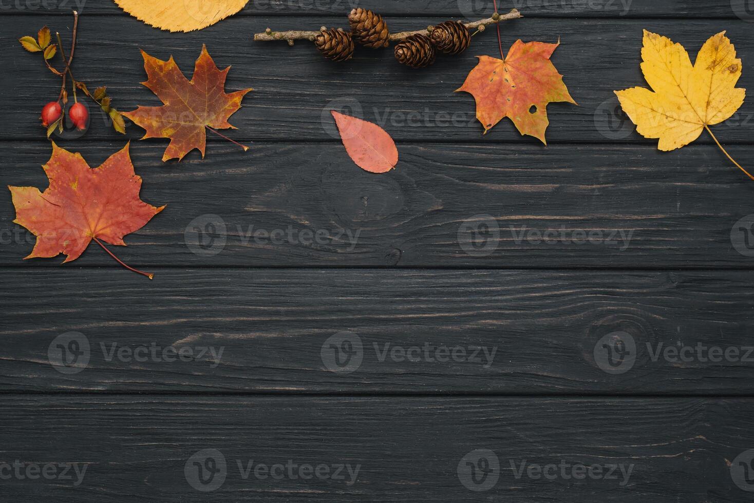 Background texture with old wooden table and yellow autumnal leaves. Autumn maple leaves on wooden background with copy space. Top view. photo