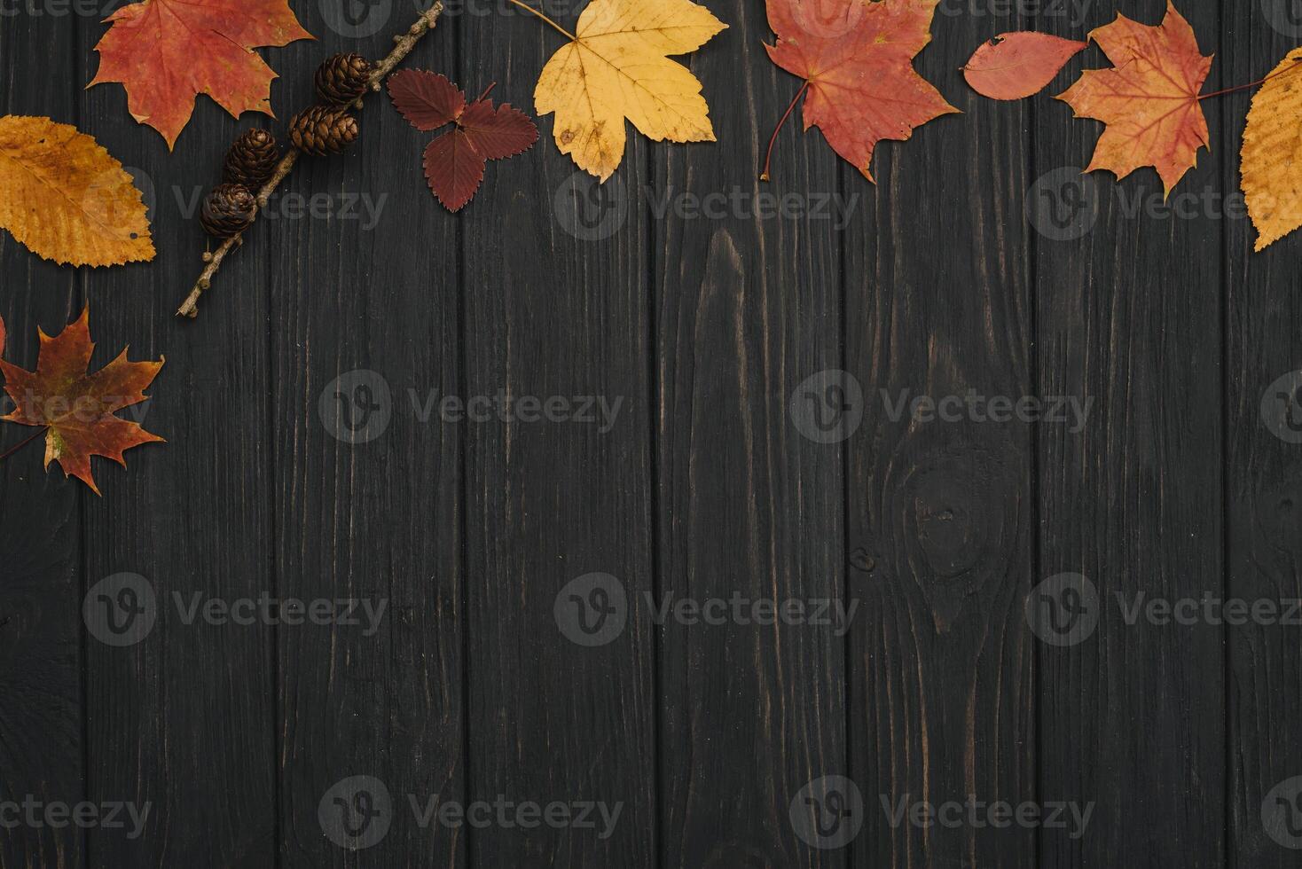 Background texture with old wooden table and yellow autumnal leaves. Autumn maple leaves on wooden background with copy space. Top view. photo