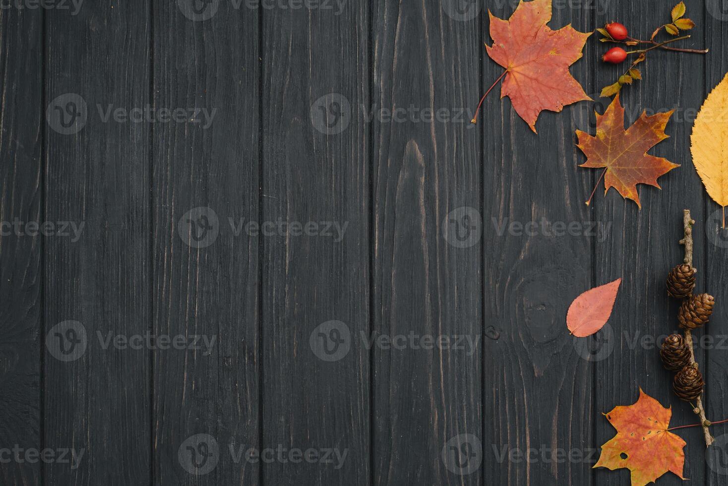 Background texture with old wooden table and yellow autumnal leaves. Autumn maple leaves on wooden background with copy space. Top view. photo