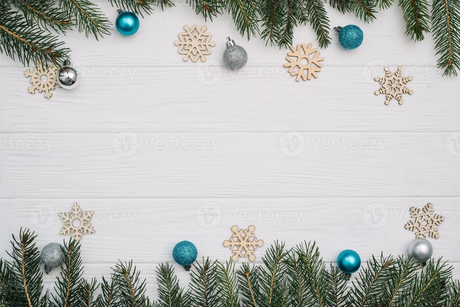 Christmas fir tree with decoration and glitters on wooden background. Christmas background on the white wooden desk. photo