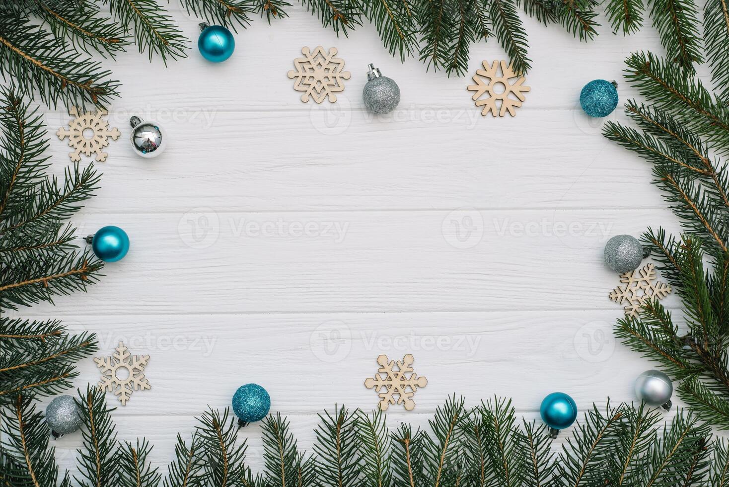 Christmas fir tree with decoration and glitters on wooden background. Christmas background on the white wooden desk photo