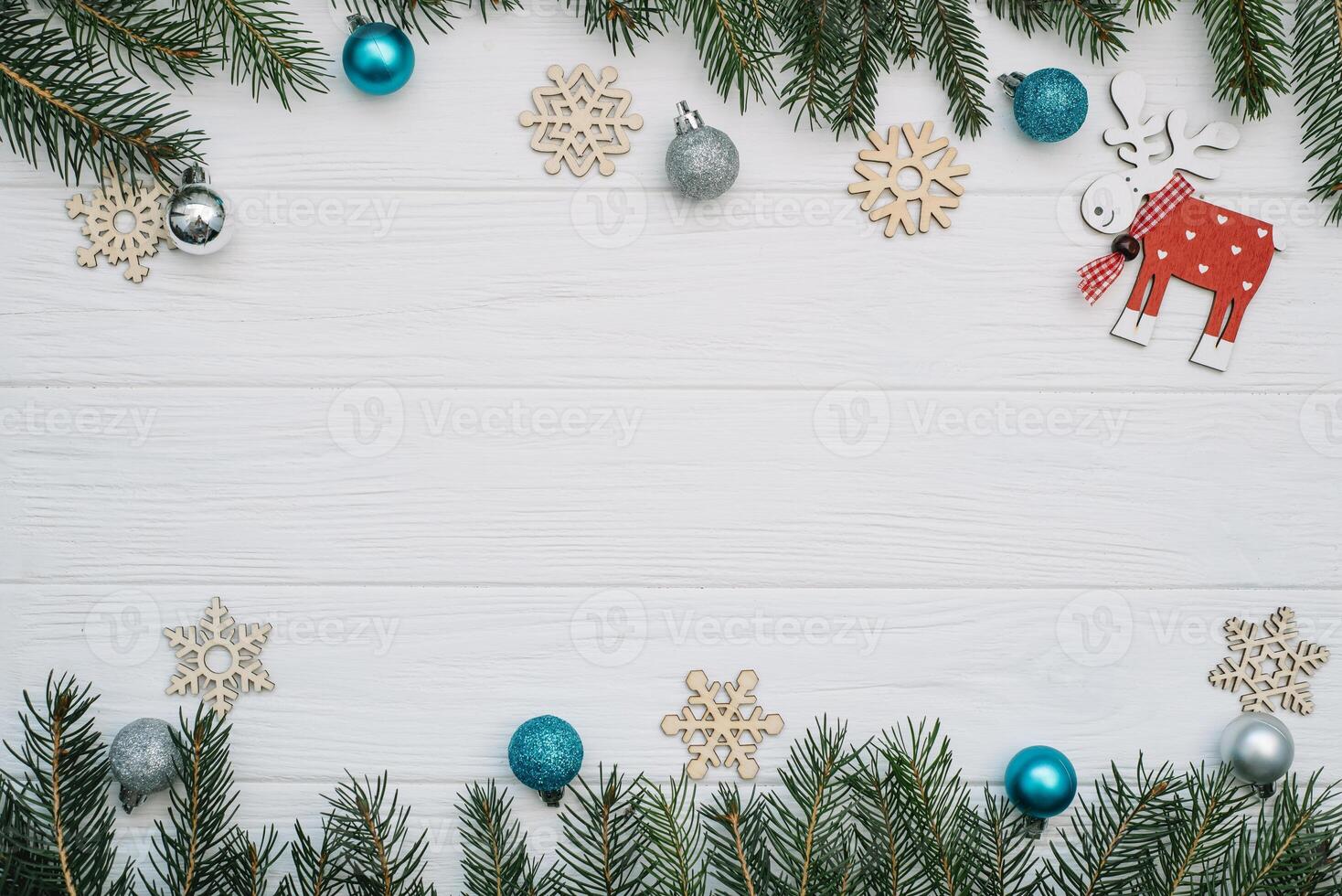 Christmas fir tree with decoration and glitters on wooden background. Christmas background on the white wooden desk. photo