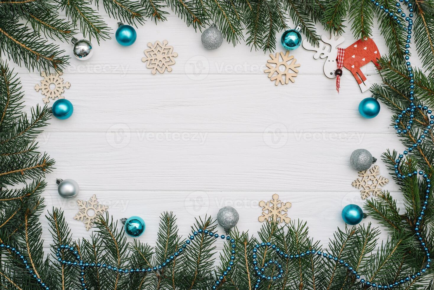 Christmas fir tree with decoration and glitters on wooden background. Christmas background on the white wooden desk photo