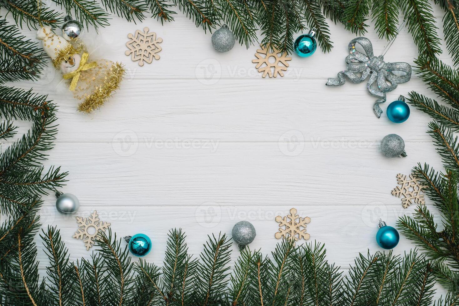 Christmas fir tree with decoration and glitters on wooden background. Christmas background on the white wooden desk photo