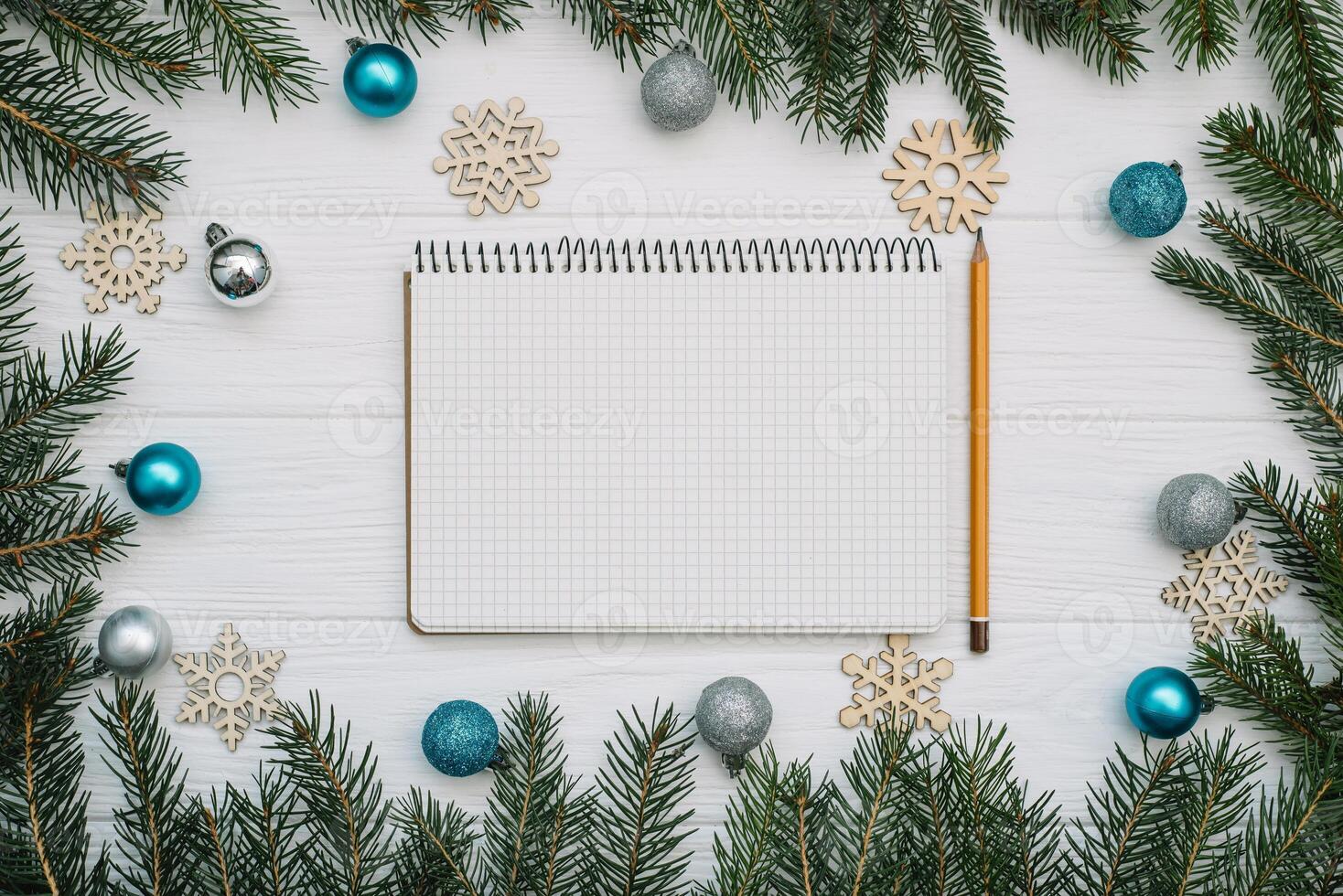 Christmas fir tree with decoration and glitters on wooden background. Christmas background on the white wooden desk photo