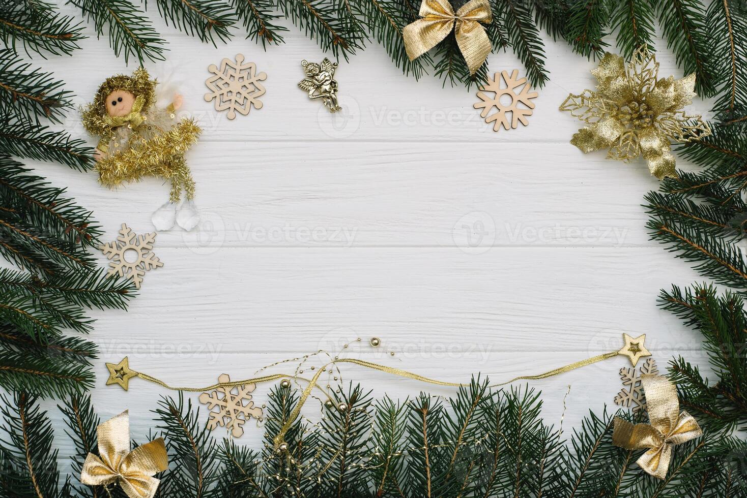 Christmas fir tree with decoration and glitters on wooden background. Christmas background on the white wooden desk photo