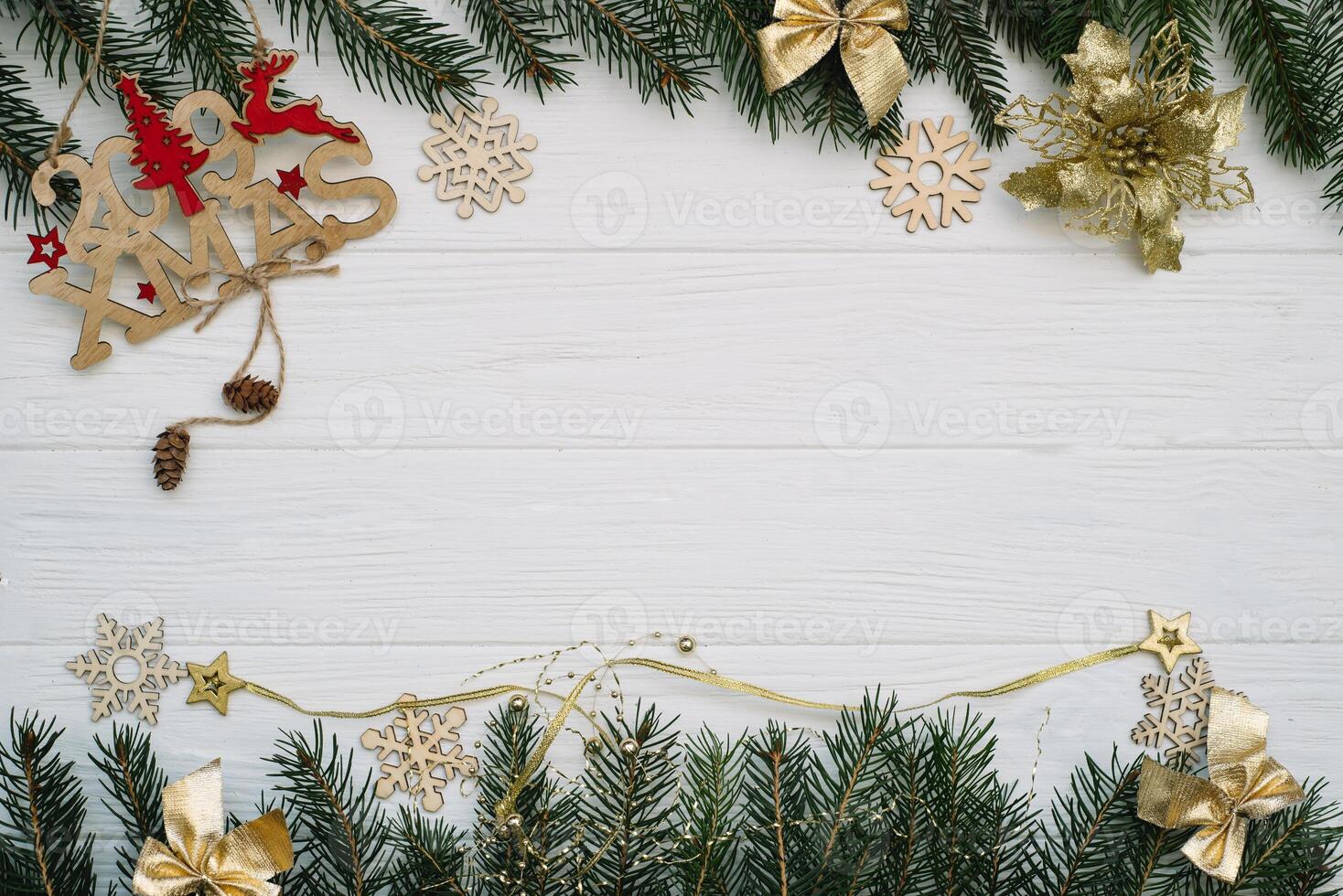 Christmas fir tree with decoration and glitters on wooden background. Christmas background on the white wooden desk photo