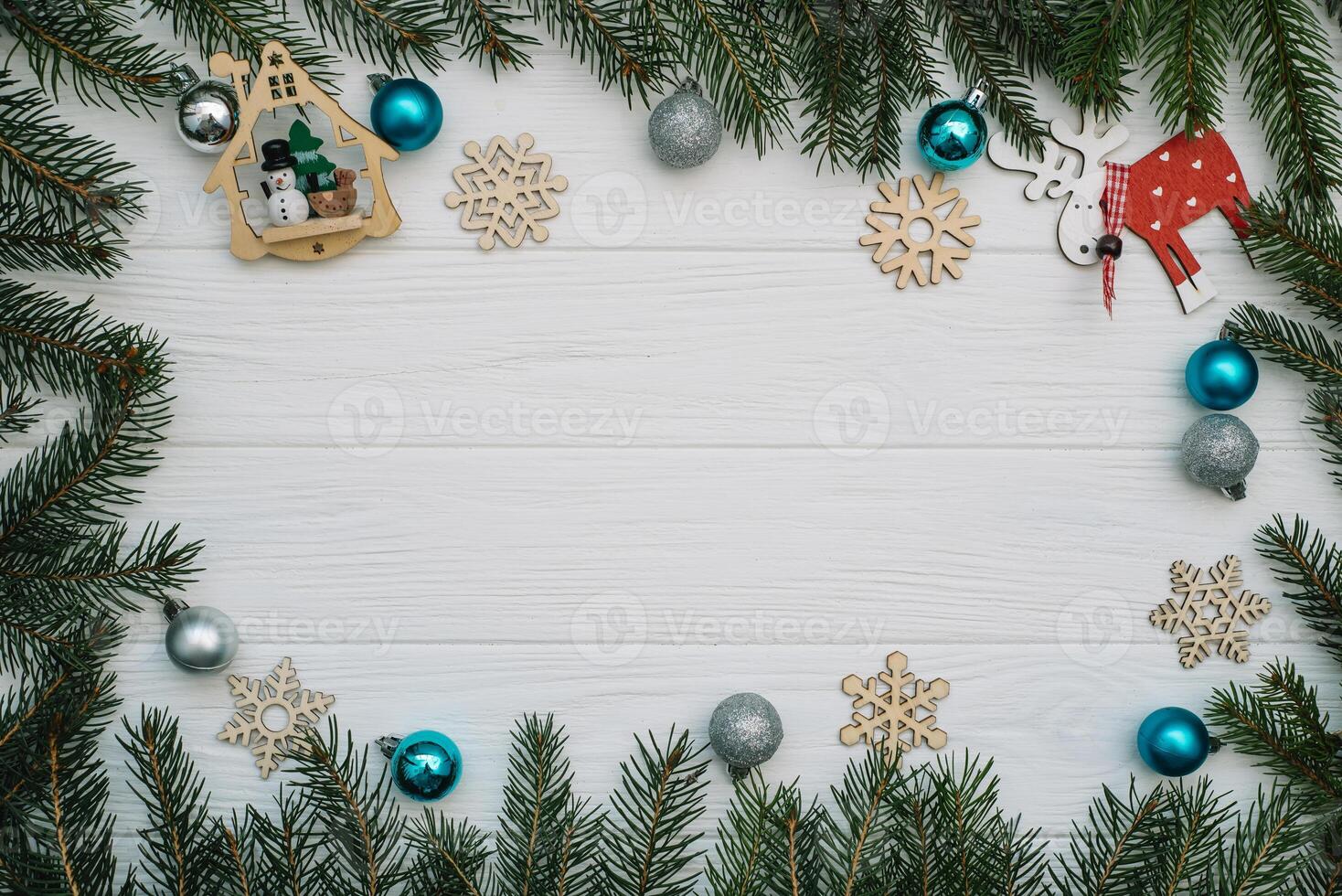 Christmas fir tree with decoration and glitters on wooden background. Christmas background on the white wooden desk photo