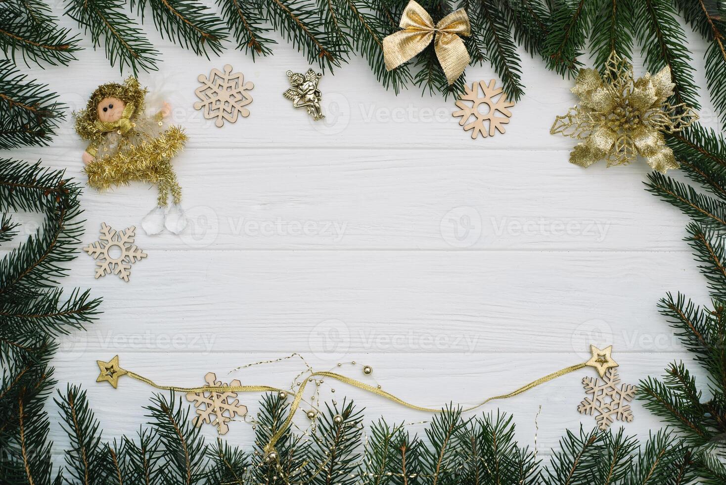 Christmas fir tree with decoration and glitters on wooden background. Christmas background on the white wooden desk photo