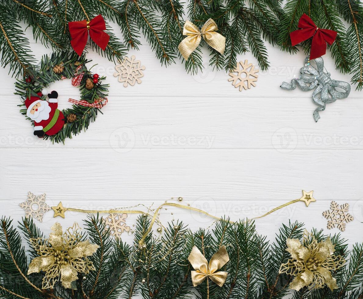 Christmas fir tree with decoration and glitters on wooden background. Christmas background on the white wooden desk photo