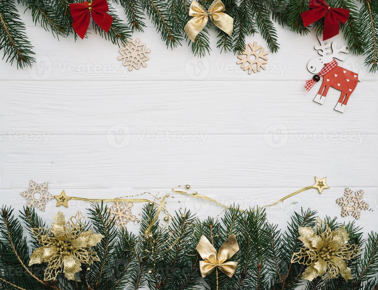 Christmas fir tree with decoration and glitters on wooden background. Christmas background on the white wooden desk photo