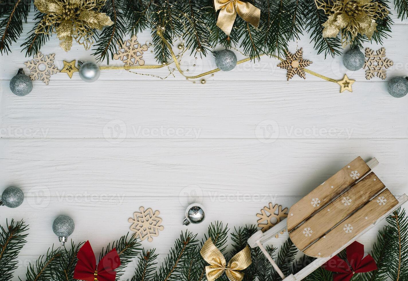 Christmas fir tree with decoration and glitters on wooden background. Christmas background on the white wooden desk photo