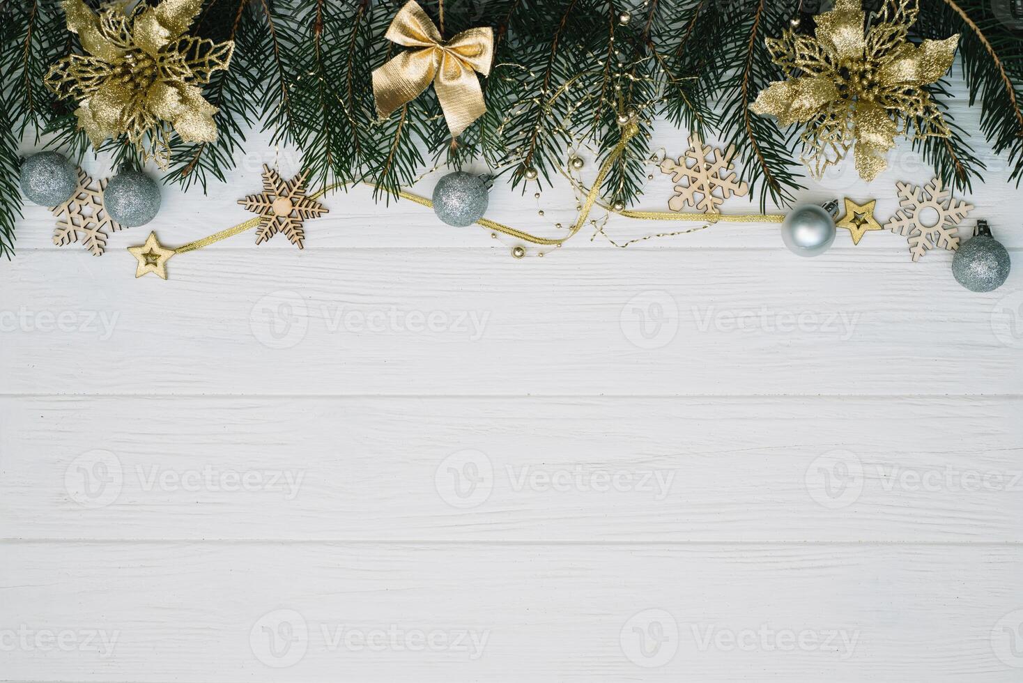 Christmas fir tree with decoration and glitters on wooden background. Christmas background on the white wooden desk photo