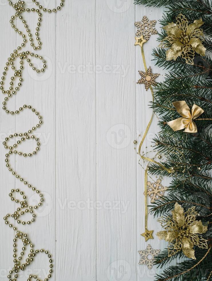 Christmas fir tree with decoration and glitters on wooden background. Christmas background on the white wooden desk photo