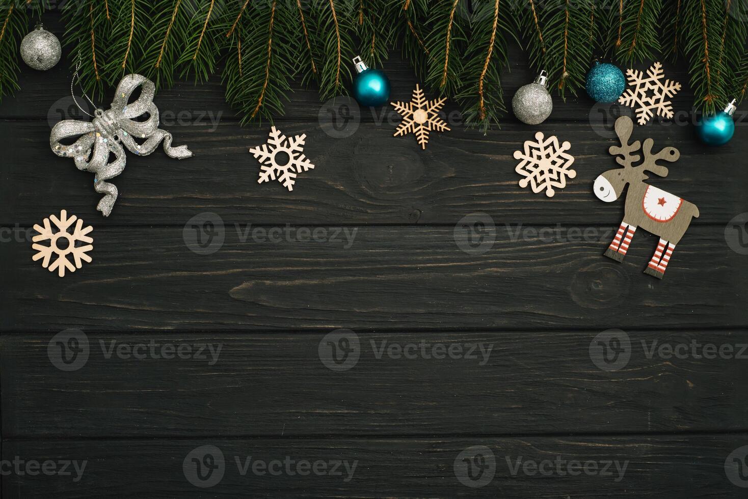 Christmas or New Year dark wooden background, Xmas black board framed with season decorations, space for a text, view from above photo