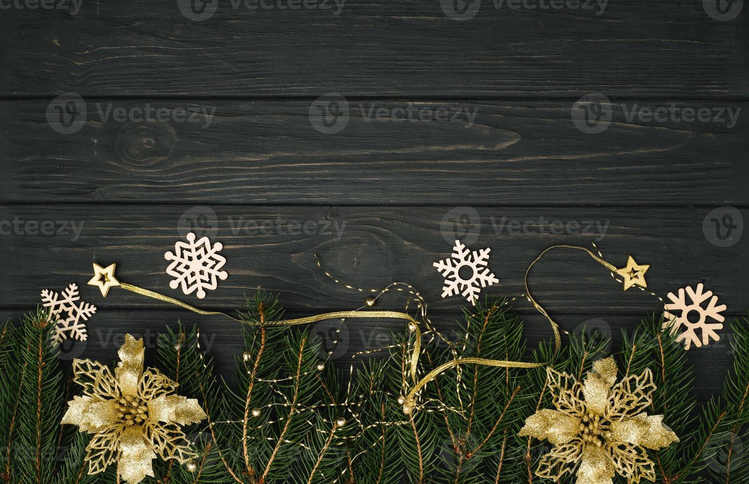 Christmas or New Year dark wooden background, Xmas black board framed with season decorations, space for a text, view from above photo