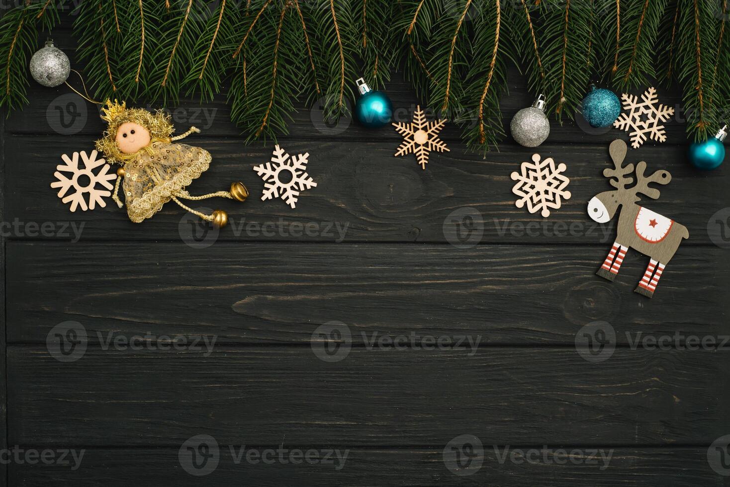 Christmas or New Year dark wooden background, Xmas black board framed with season decorations, space for a text, view from above photo
