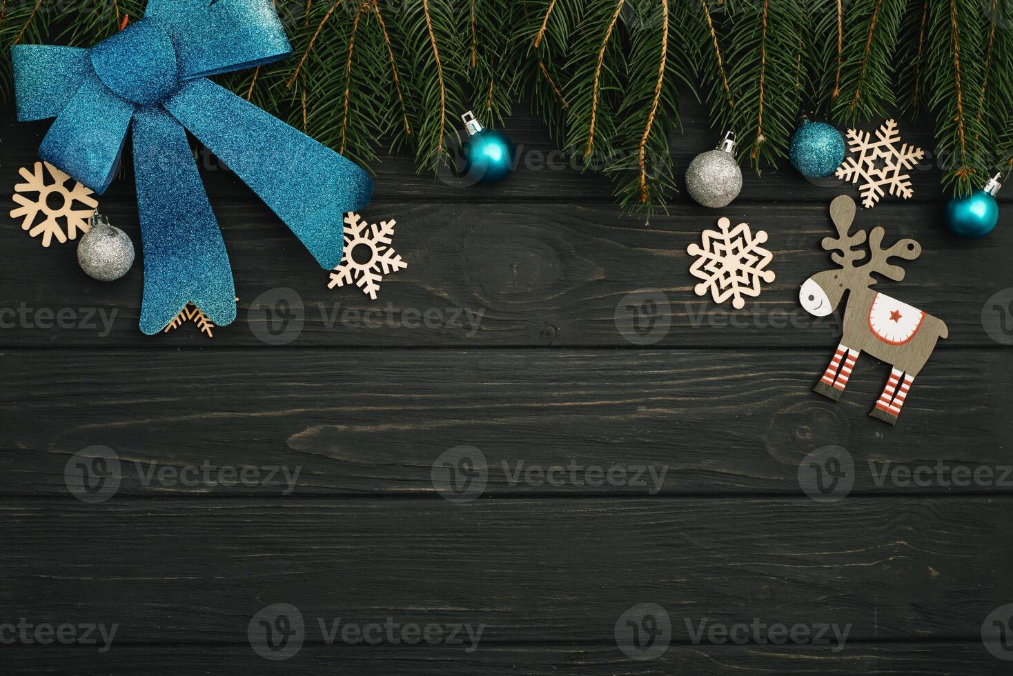 Christmas or New Year dark wooden background, Xmas black board framed with season decorations, space for a text, view from above photo