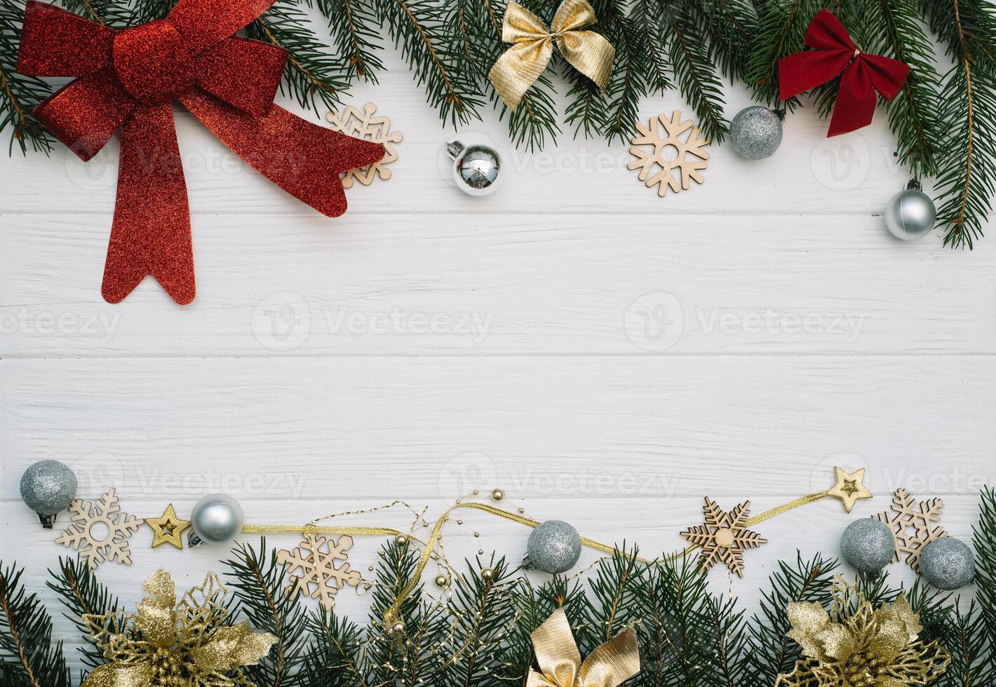 Christmas fir tree with decoration and glitters on wooden background. Christmas background on the white wooden desk photo