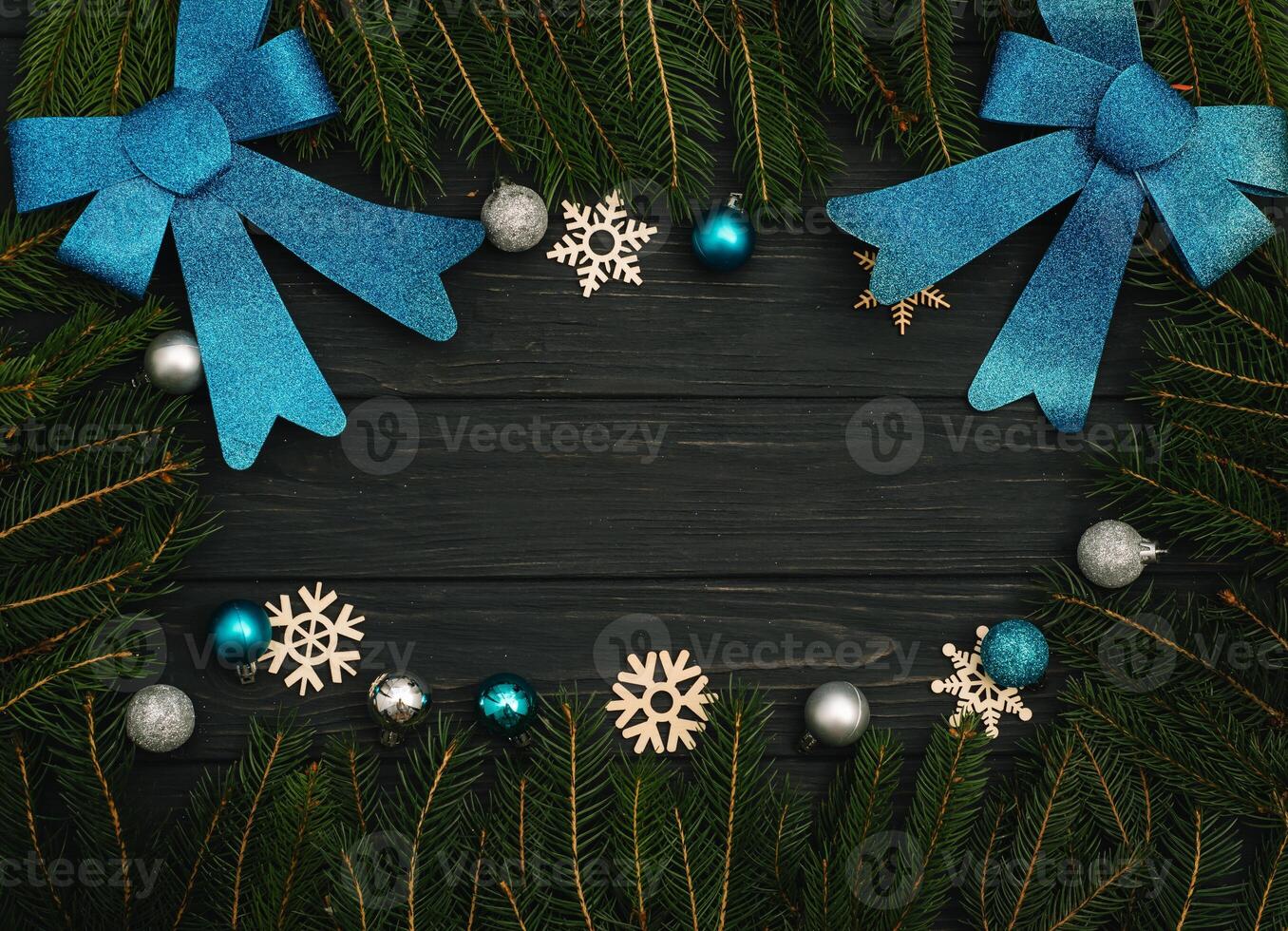 Christmas or New Year dark wooden background, Xmas black board framed with season decorations, space for a text, view from above photo