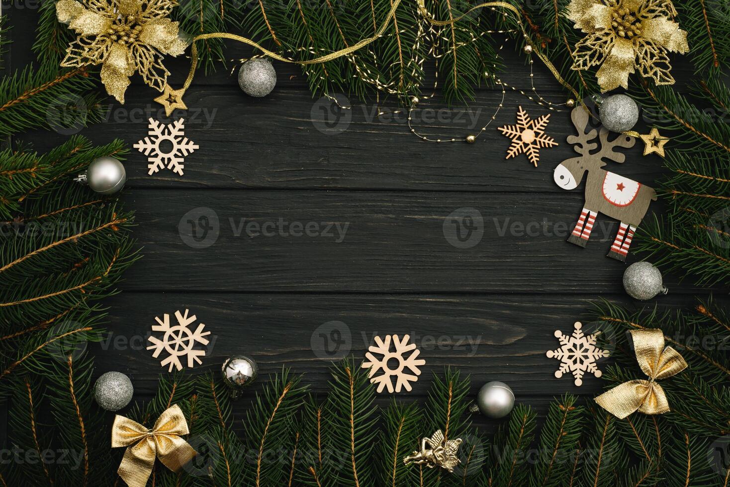 Christmas or New Year dark wooden background, Xmas black board framed with season decorations, space for a text, view from above photo